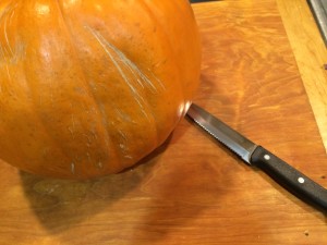Use a small, heavy, serrated knife to remove the stem and carve the pumpkin.