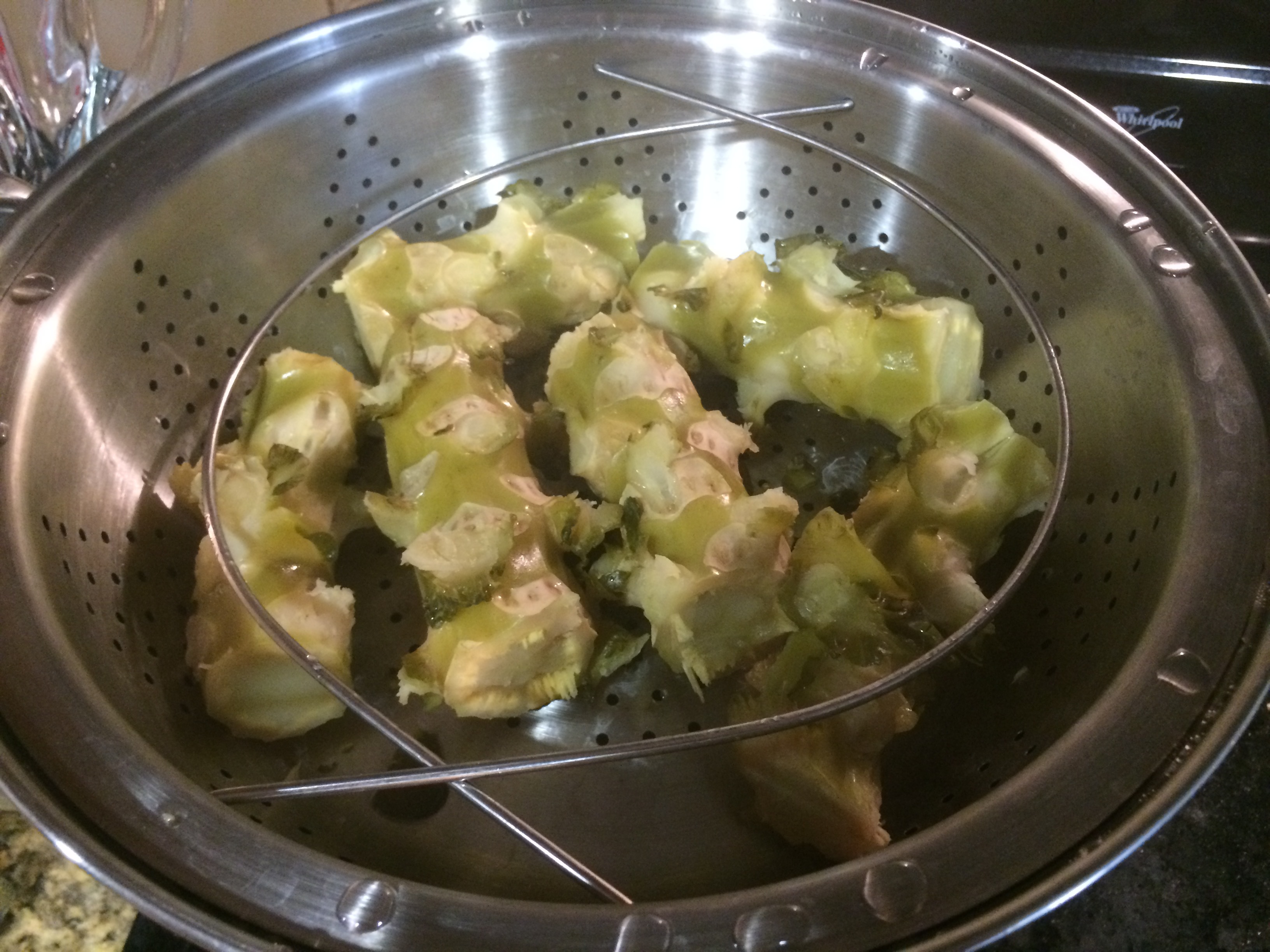 Brussels sprout stalk pieces beginning to crack after one hour of steaming