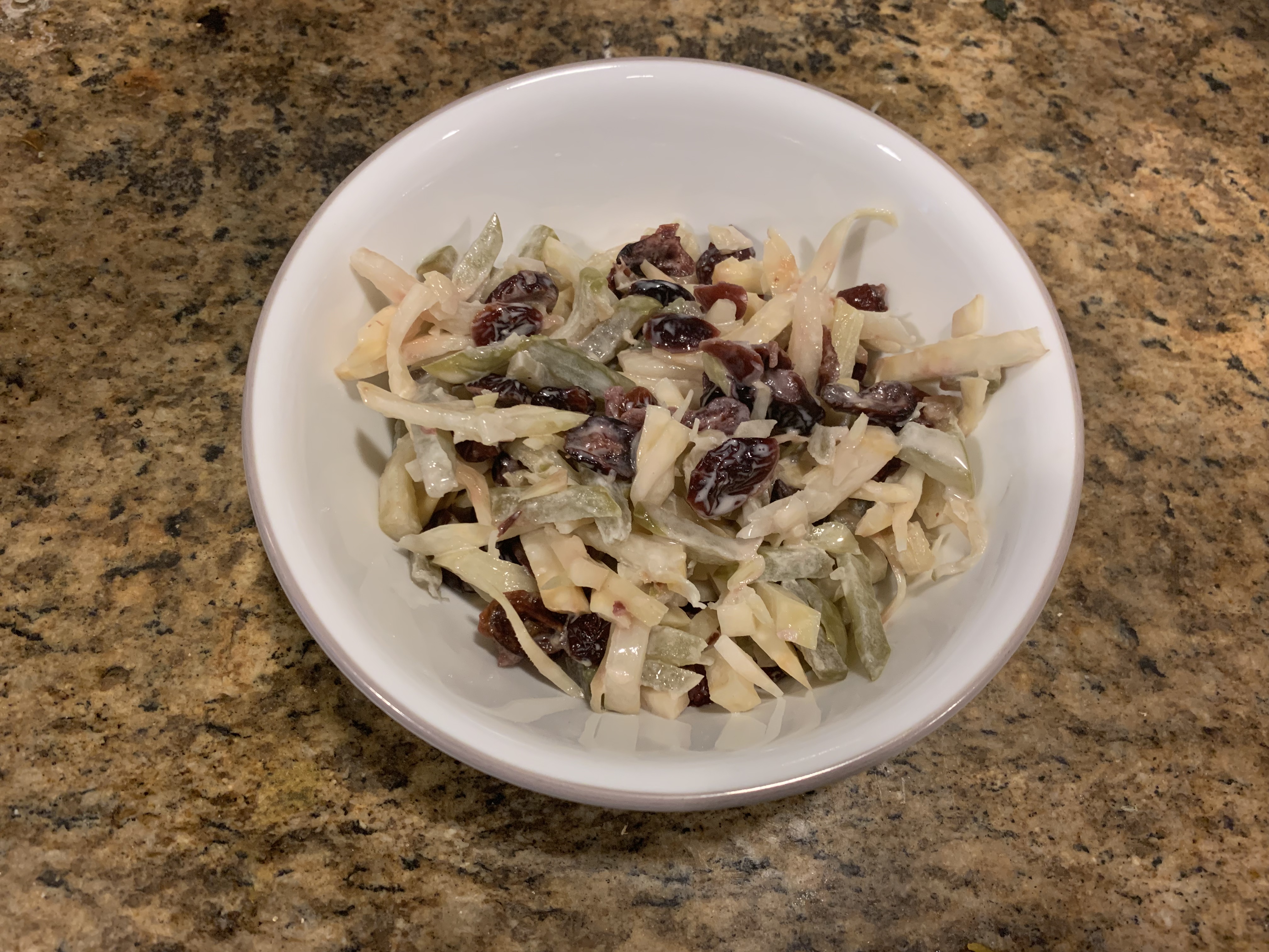 A serving of fermented celeriac, kohlrabi, and apple slaw with dried cranberries